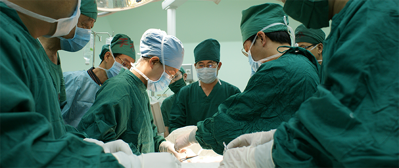 Surgeons working over a patient
